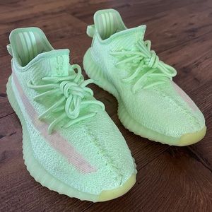 Glow in the dark, neon green Yeezy sneaker.